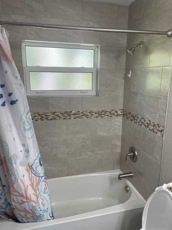 bathroom featuring shower / tub combo with curtain