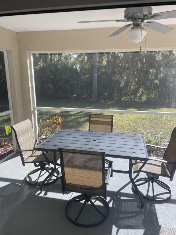 sunroom featuring ceiling fan