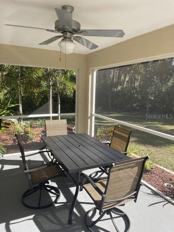 sunroom / solarium featuring ceiling fan