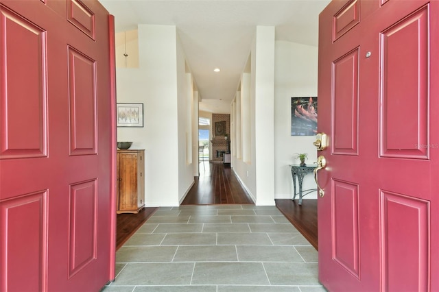 entryway featuring a large fireplace and light wood-type flooring