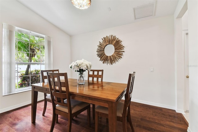 dining area with dark hardwood / wood-style flooring and vaulted ceiling