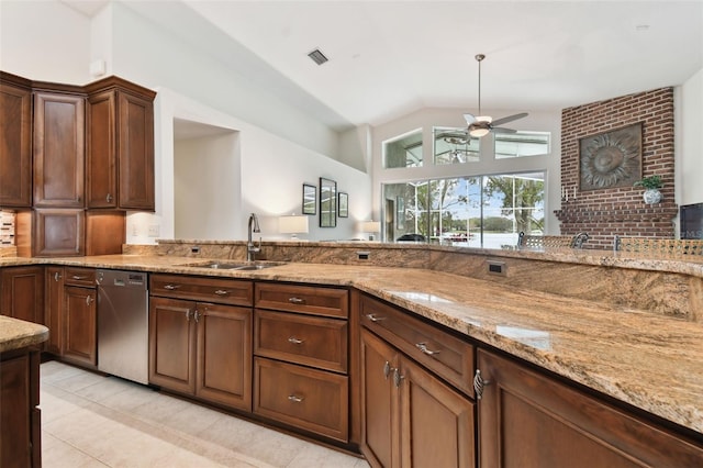 kitchen with dishwasher, sink, light tile patterned floors, ceiling fan, and light stone counters