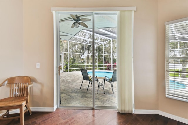 doorway to outside featuring ceiling fan, dark hardwood / wood-style flooring, and a wealth of natural light