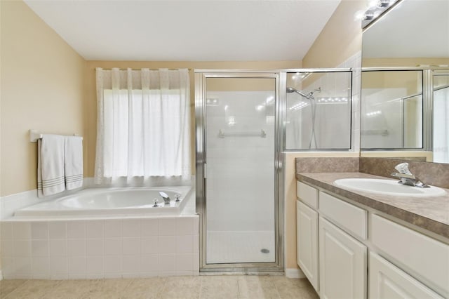 bathroom featuring tile patterned flooring, vanity, and shower with separate bathtub