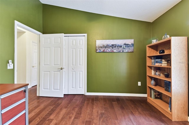 unfurnished bedroom with dark wood-type flooring and a closet