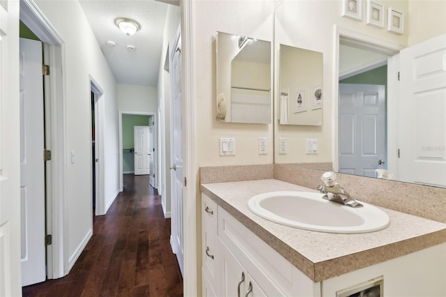 bathroom with vanity, hardwood / wood-style floors, and a textured ceiling