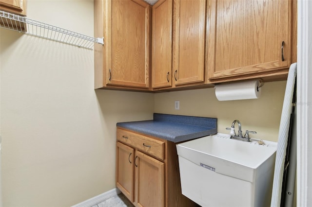 clothes washing area featuring sink