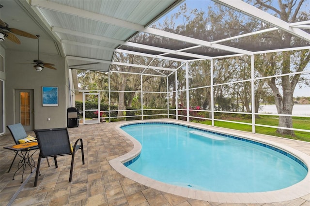 view of swimming pool featuring ceiling fan, a lanai, and a patio area