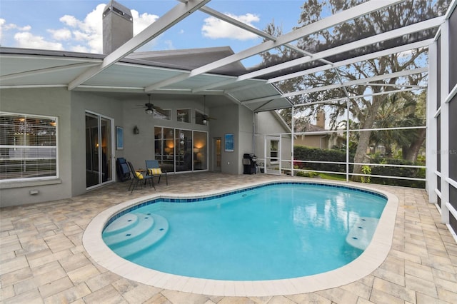 view of swimming pool featuring a lanai, a patio, and ceiling fan