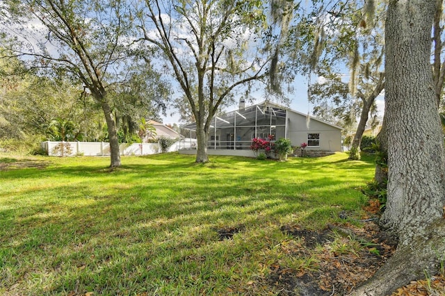 view of yard with glass enclosure