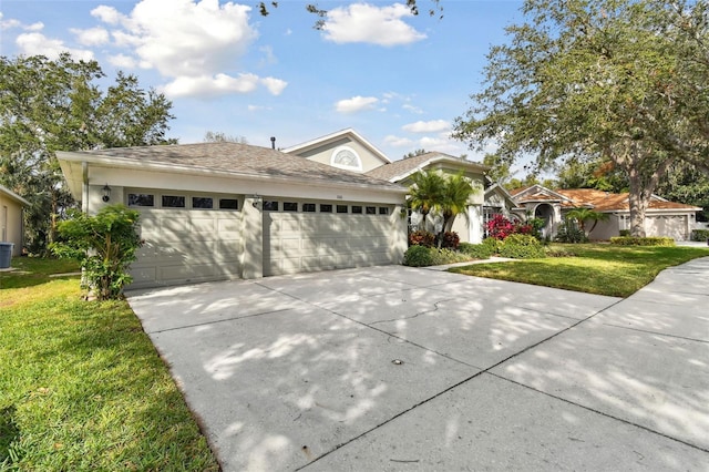 view of front of home with a garage and a front lawn