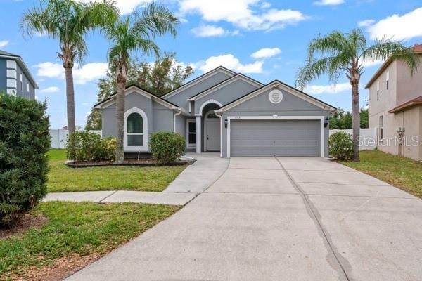 view of front of property with a garage and a front lawn