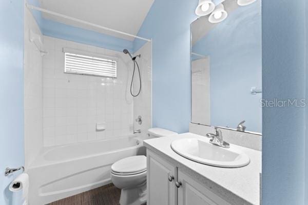 full bathroom with hardwood / wood-style floors, vanity,  shower combination, and toilet