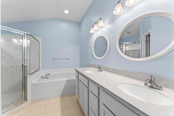 bathroom with tile patterned flooring, vanity, lofted ceiling, and independent shower and bath