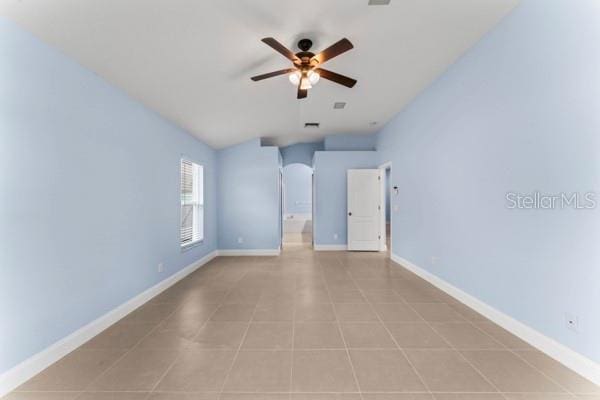 spare room featuring ceiling fan and light tile patterned floors