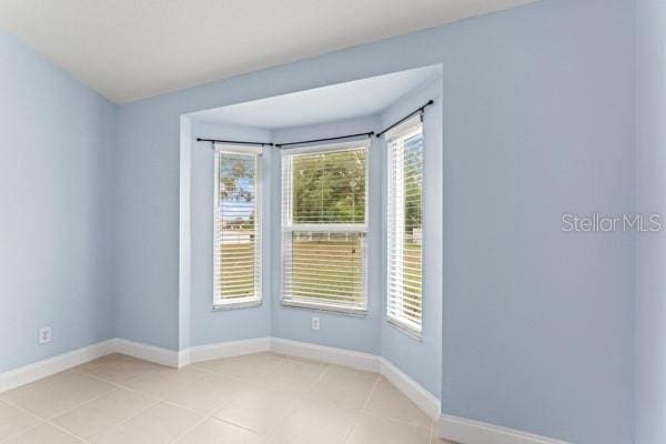 empty room with light tile patterned floors