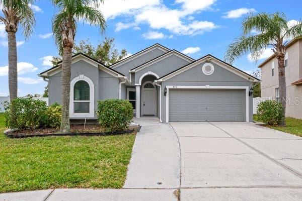 view of front of home with a front lawn and a garage