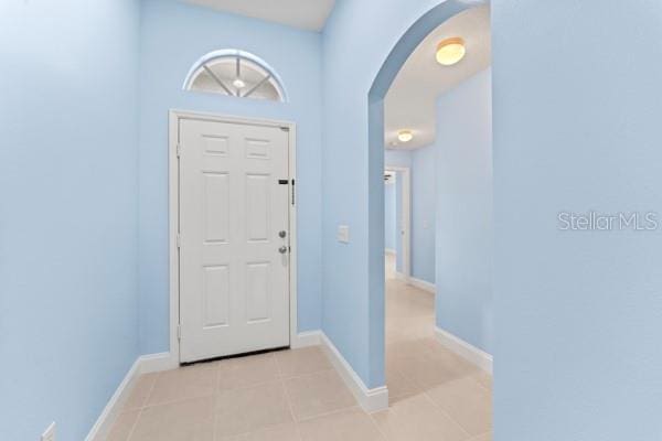 foyer entrance with light tile patterned flooring