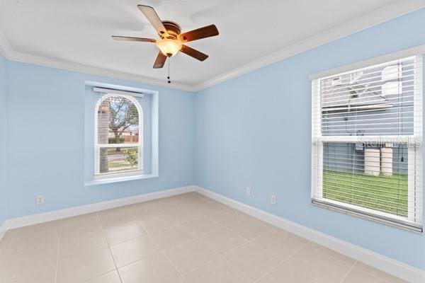 tiled spare room with ceiling fan and crown molding