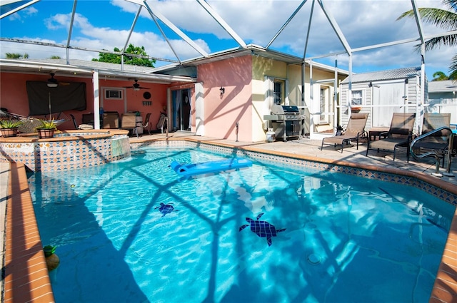 view of swimming pool featuring an in ground hot tub, a patio area, a grill, ceiling fan, and a lanai