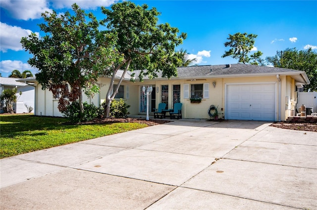 ranch-style house with a garage and a front lawn