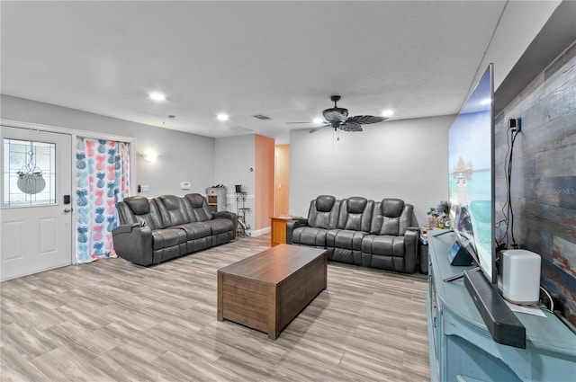 living room with light hardwood / wood-style floors and ceiling fan