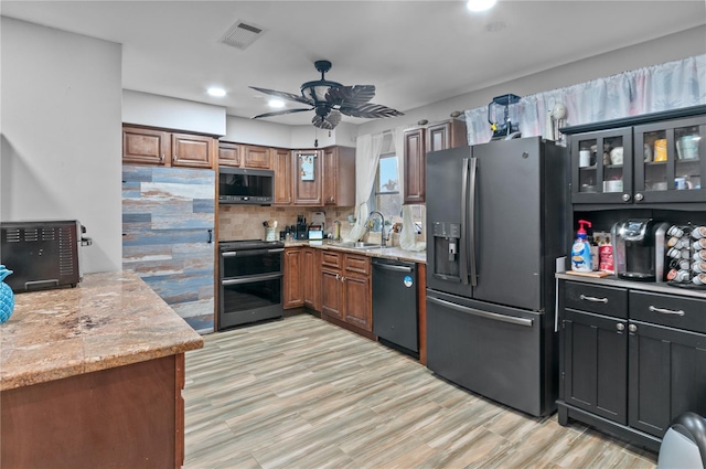 kitchen with tasteful backsplash, dishwasher, sink, stainless steel fridge, and stove