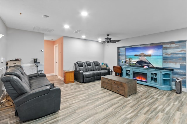 living room featuring ceiling fan and light wood-type flooring