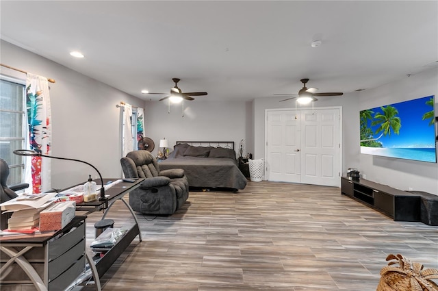 living room featuring ceiling fan and light hardwood / wood-style floors