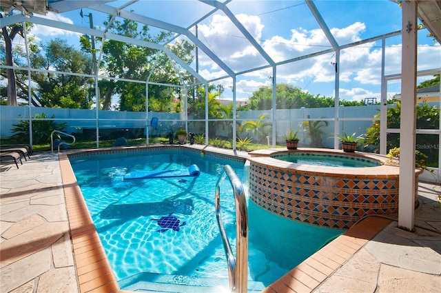 view of swimming pool featuring a lanai, a patio, and an in ground hot tub