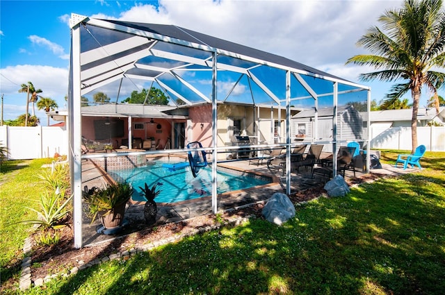 view of swimming pool featuring a patio area, a lawn, and glass enclosure