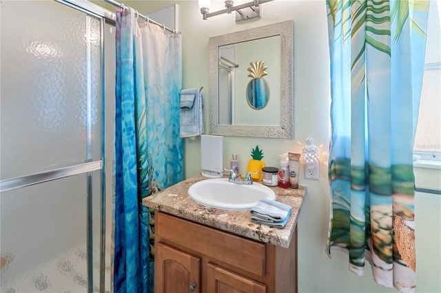 bathroom with vanity and a shower