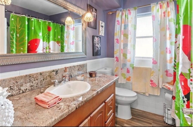 bathroom featuring vanity, hardwood / wood-style flooring, toilet, and a shower with shower curtain