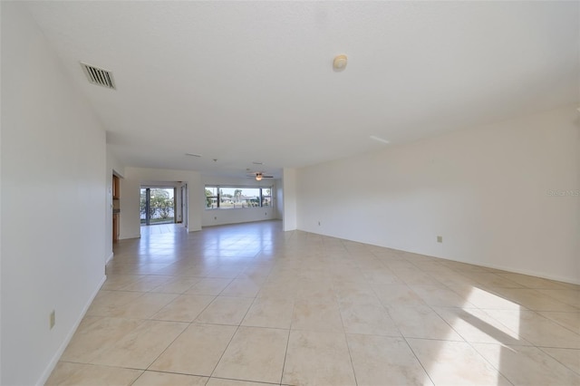 tiled empty room with ceiling fan