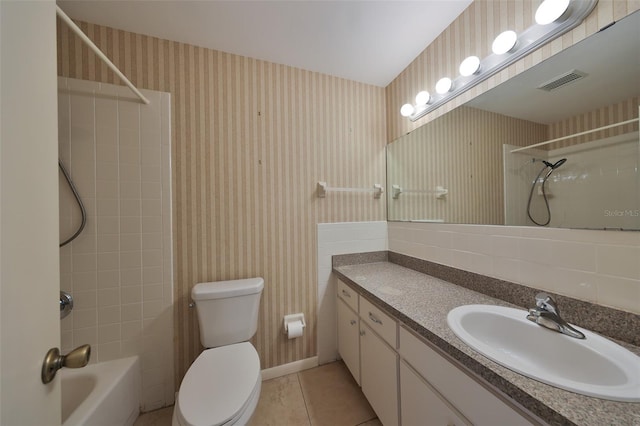 full bathroom with tasteful backsplash, tile patterned floors, vanity, toilet, and tiled shower / bath