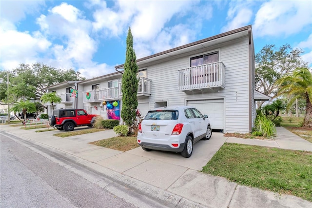 townhome / multi-family property featuring a balcony and a garage