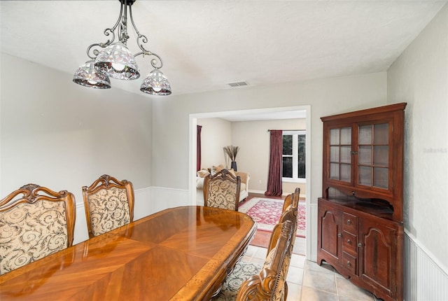 dining area with light tile patterned floors and a textured ceiling