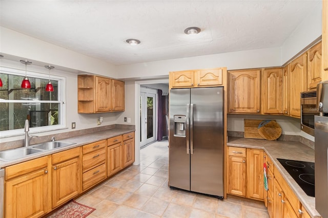 kitchen with appliances with stainless steel finishes, a textured ceiling, sink, light tile patterned floors, and decorative light fixtures