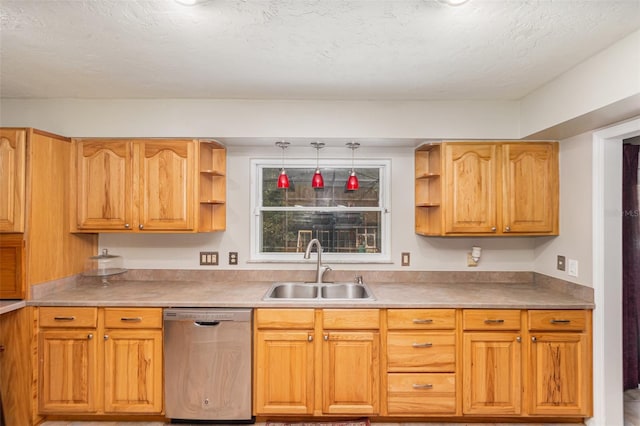 kitchen with decorative light fixtures, sink, stainless steel dishwasher, and a textured ceiling