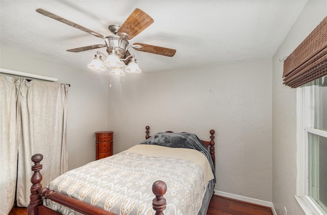 bedroom featuring ceiling fan and dark hardwood / wood-style flooring