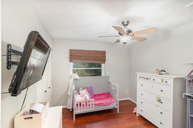 bedroom with ceiling fan and dark wood-type flooring