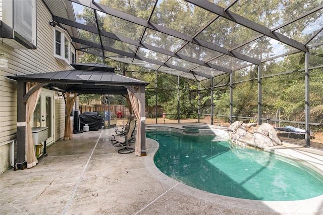 view of pool featuring an in ground hot tub, a gazebo, a patio, and a lanai