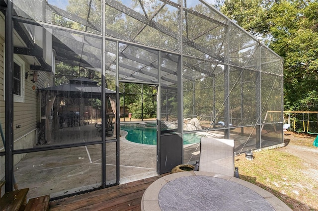 view of pool featuring a patio and glass enclosure