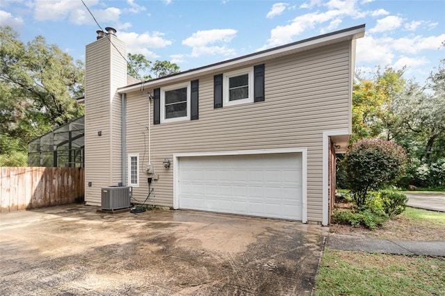 view of home's exterior with a garage and central AC unit