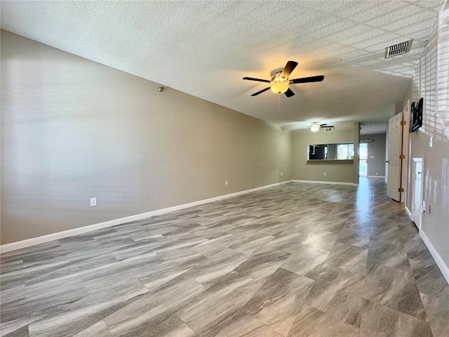 unfurnished room featuring a textured ceiling and ceiling fan