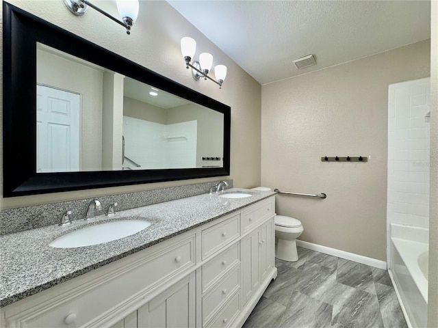 full bathroom with vanity, toilet, a textured ceiling, and bathtub / shower combination