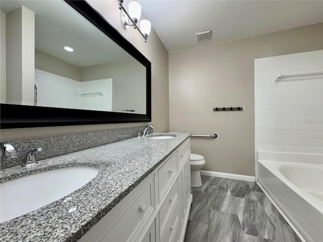 full bathroom featuring bathing tub / shower combination, vanity, and toilet