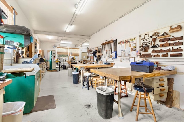 miscellaneous room featuring a workshop area and concrete floors