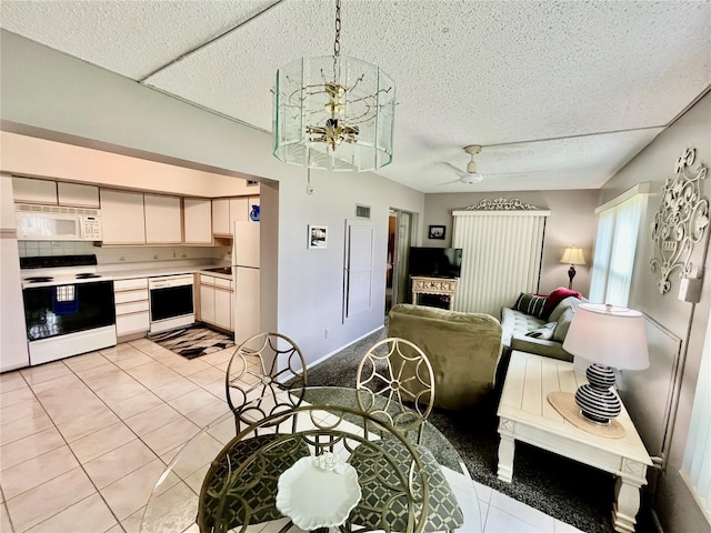 interior space with a notable chandelier, a textured ceiling, and light tile patterned flooring