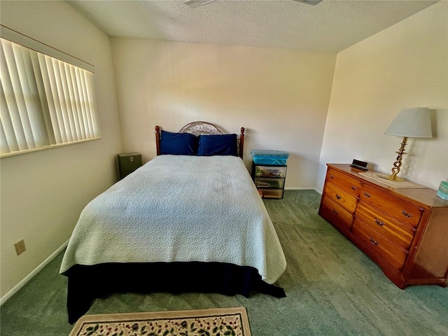 bedroom featuring carpet flooring, baseboards, and a textured ceiling